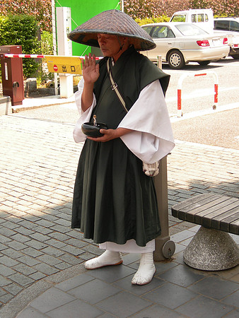 A monk from the local temple - they beg silently as part of their duties to the shrine.